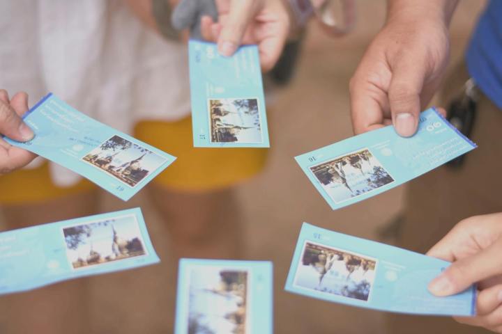 close up of a group of people holding tickets